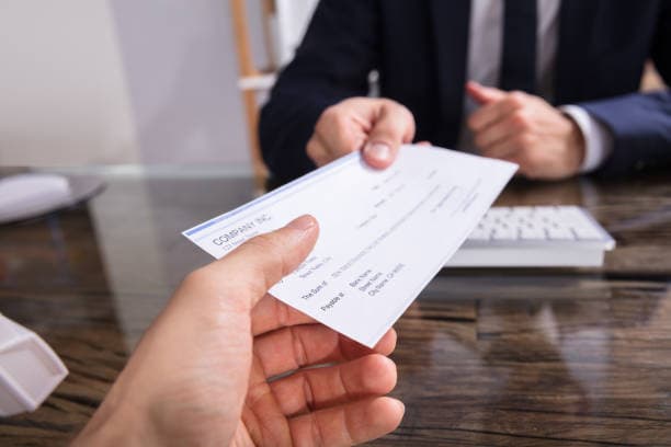 Handing over a business cheque during a payment